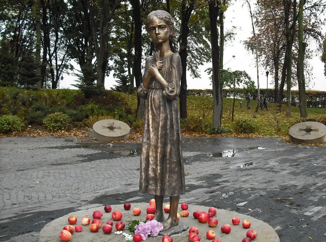 Statue of a famished girl clutching a head of wheat